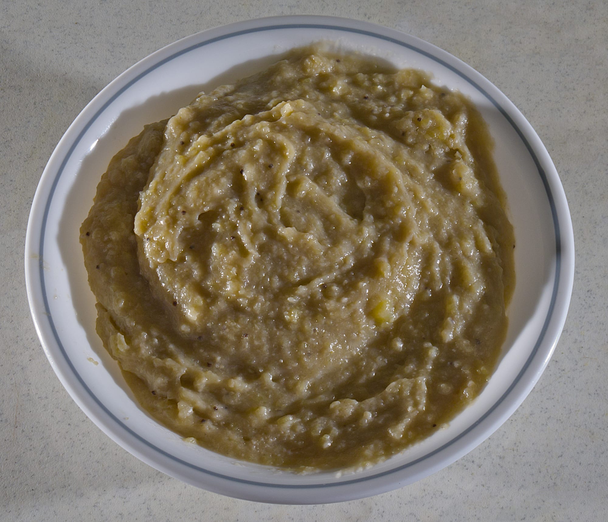 A plate of smooth, pale mashed plantain