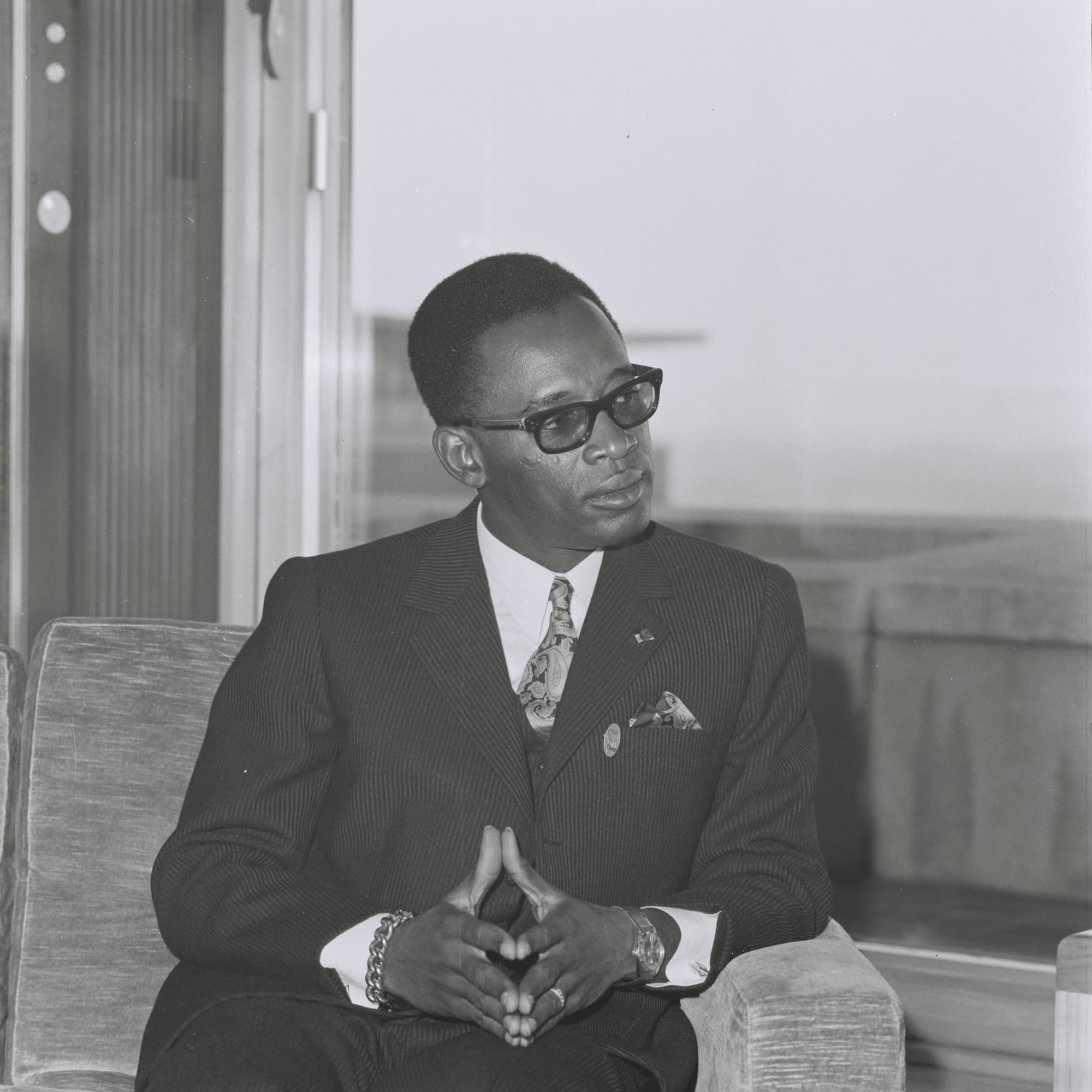 Mobutu Sese Seko in his trademark leopard-skin hat and thick glasses