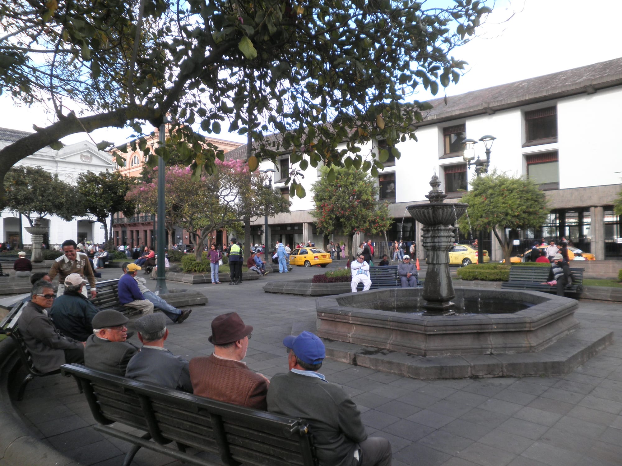 A dense colonial city of white and terracotta buildings and church domes filling a high Andean valley
