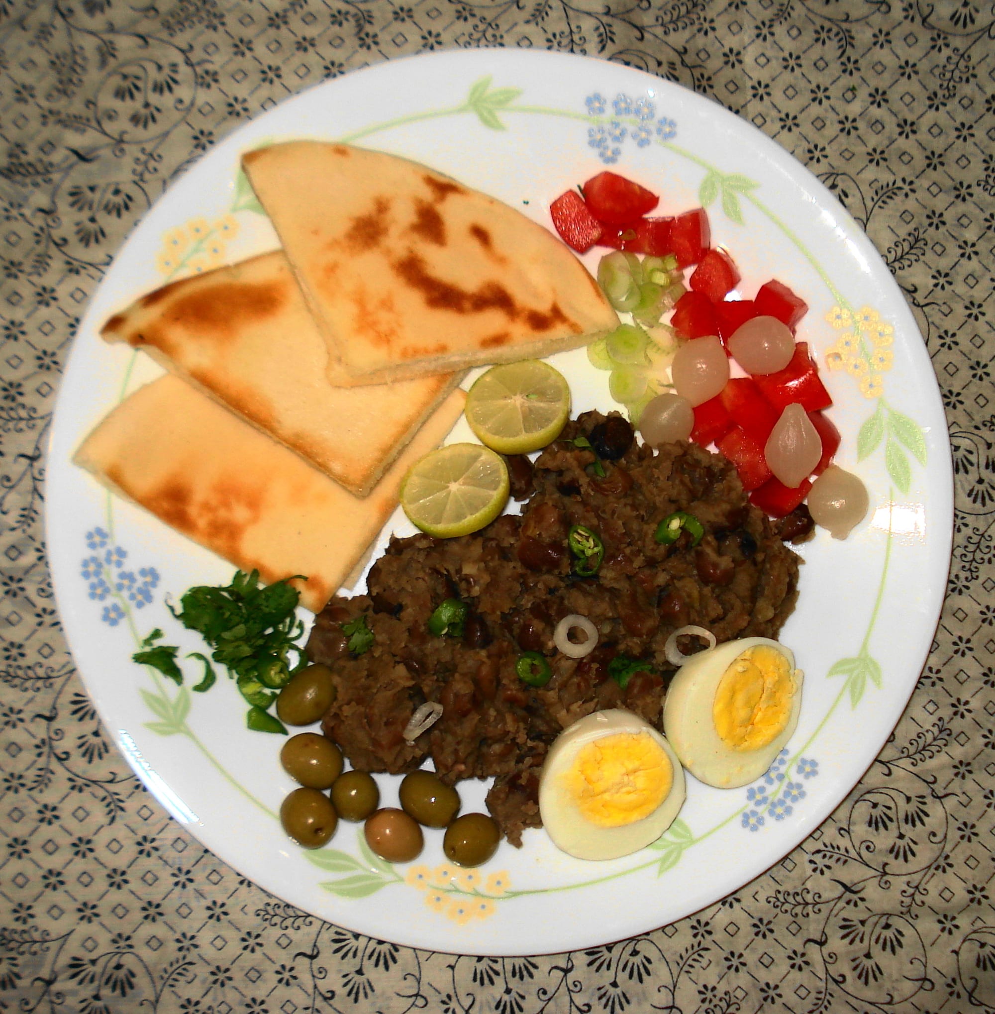 A bowl of mashed fava beans drizzled with oil