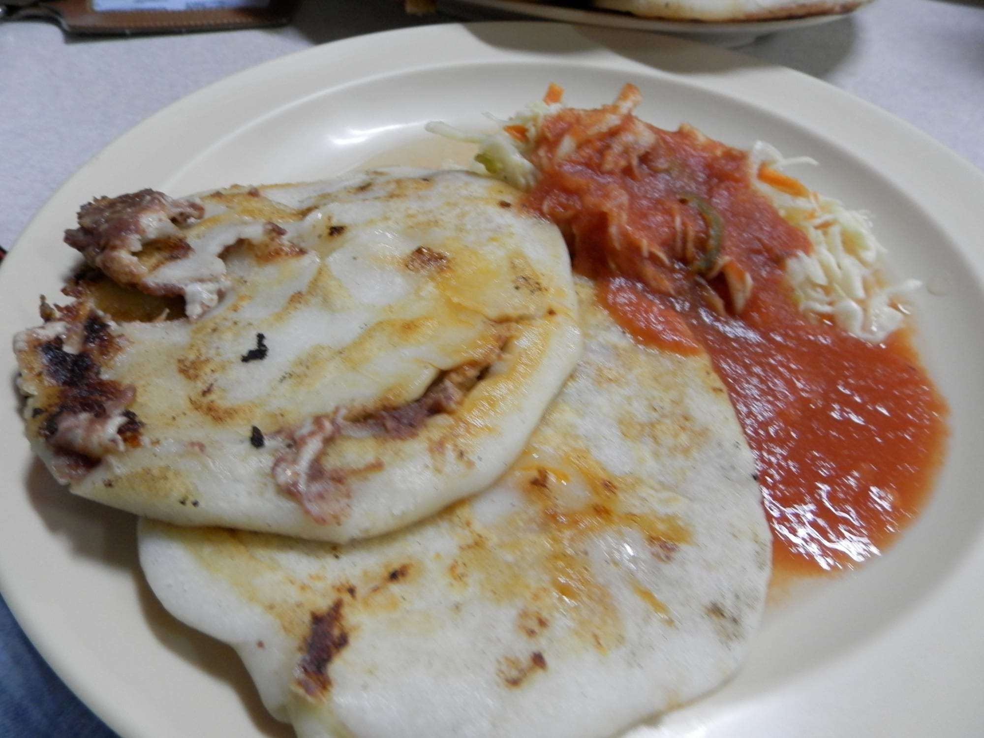 Thick stuffed corn tortillas served with pickled cabbage slaw and tomato salsa