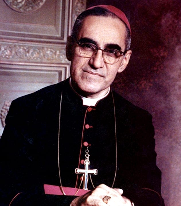 A portrait of Archbishop Óscar Romero in glasses and clerical dress, looking to the side