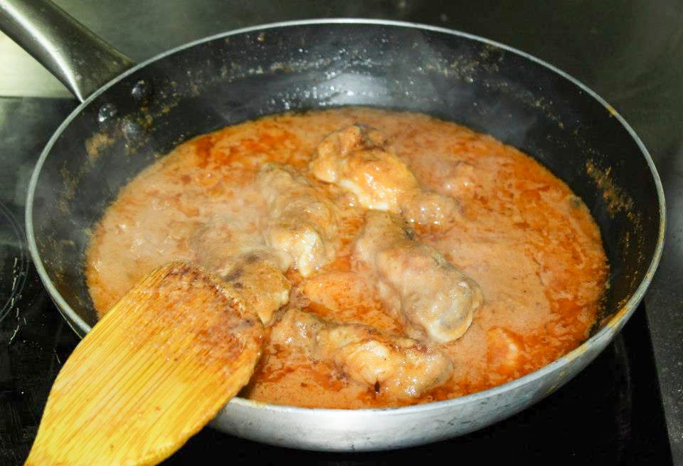 Pieces of chicken in a thick peanut-based sauce