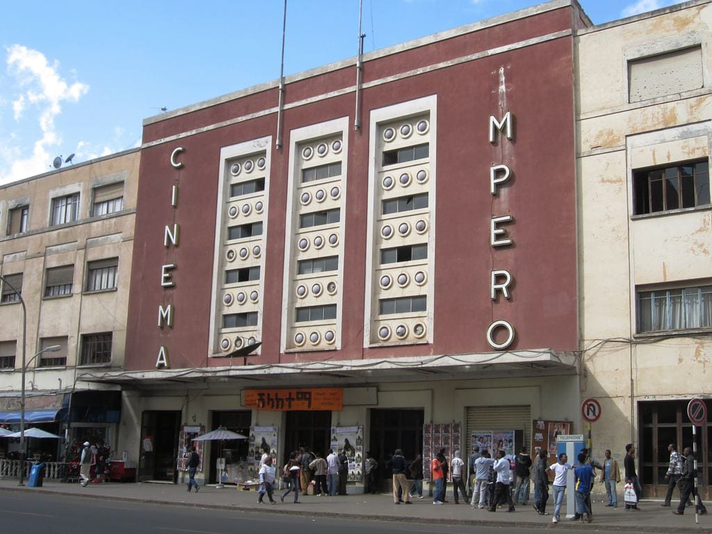 A streamlined 1930s cinema facade with vertical fins and 'IMPERO' lettering