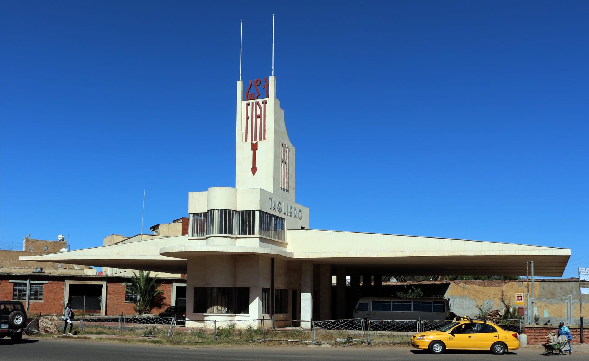 The cantilevered concrete wings of a modernist building against a blue sky