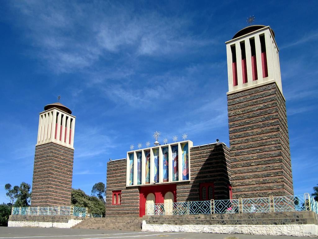 A tall stone church with a striking blend of Italian and Ethiopian-Eritrean architectural forms