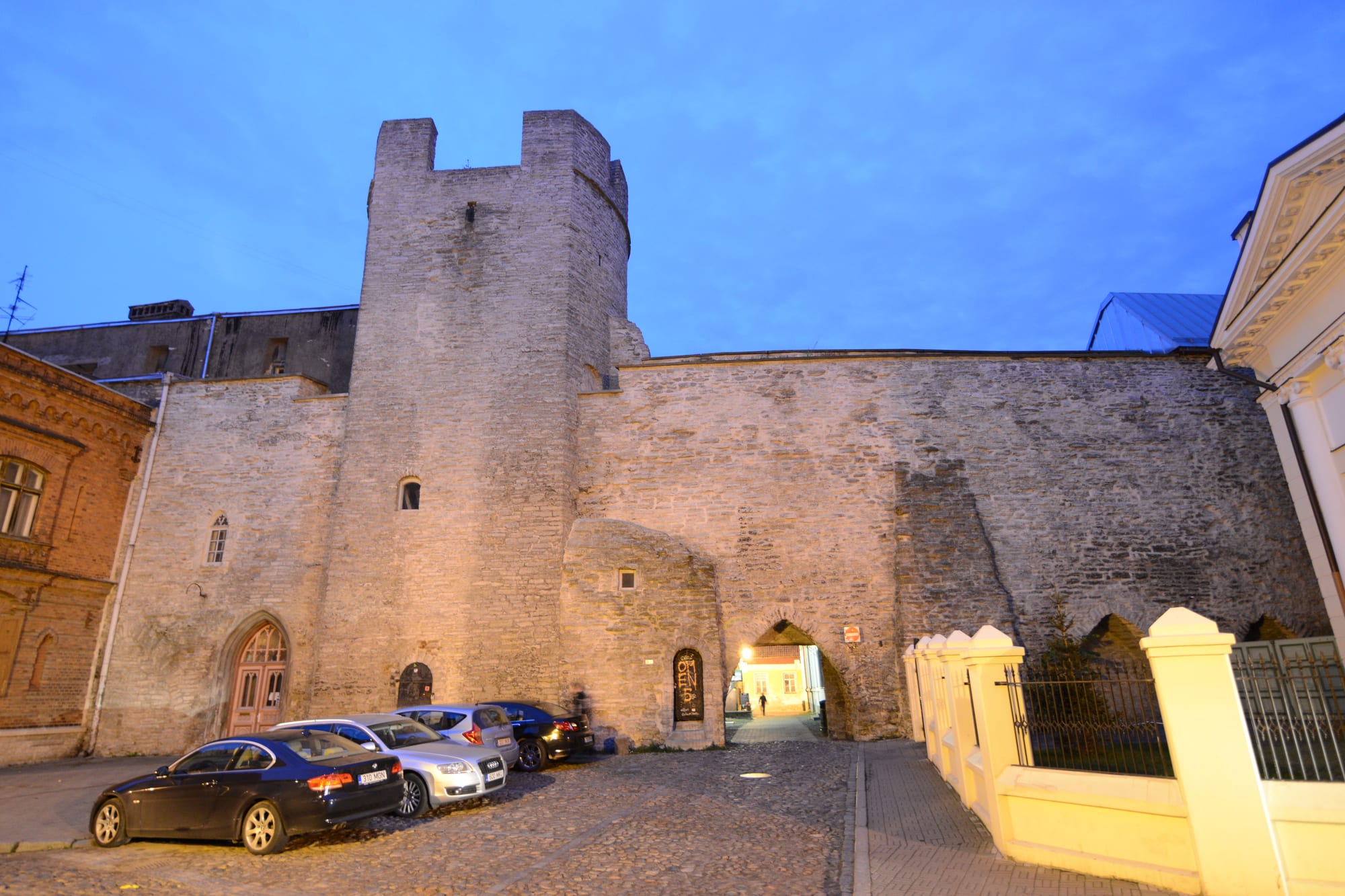 A run of red-roofed round towers linked by a high stone wall