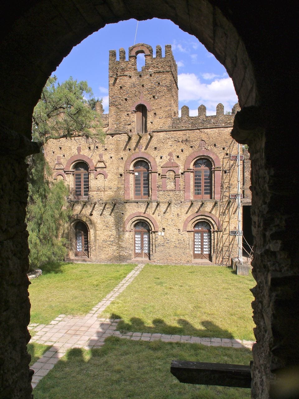 A group of stone castles with round towers and battlements on a walled compound