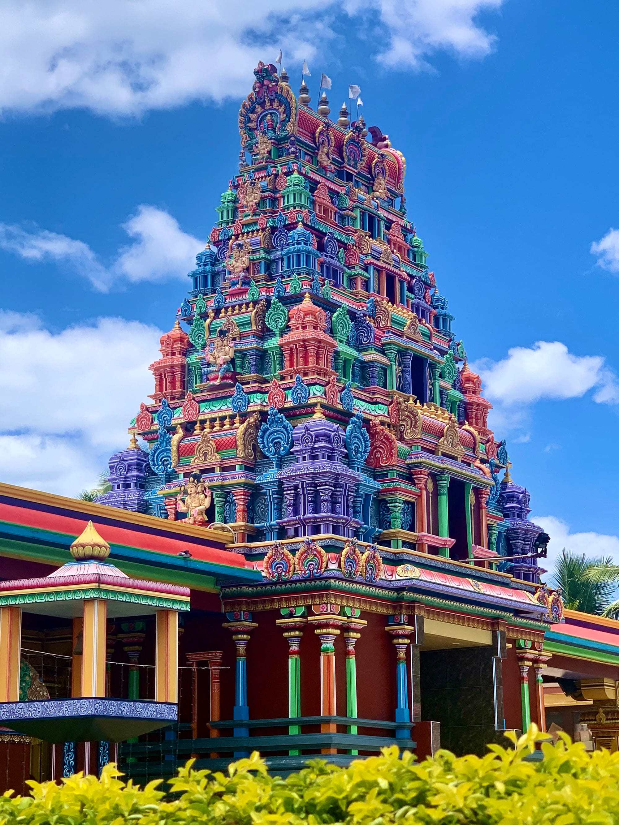 A South Indian temple gate tower covered in vividly painted carved figures