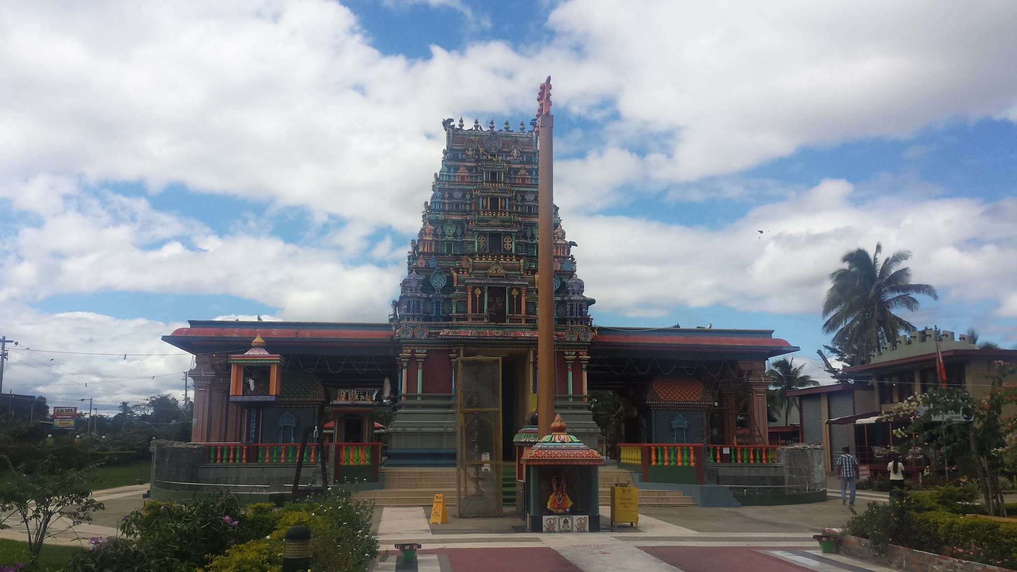 A brightly painted South Indian style Hindu temple gateway covered in sculpted figures