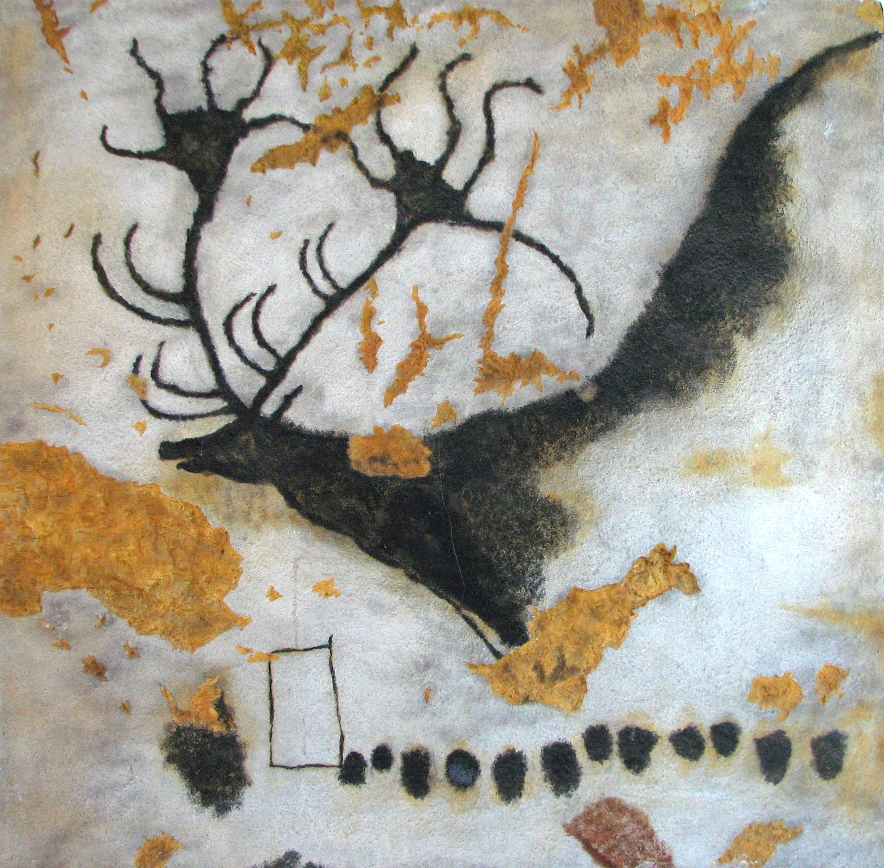 A prehistoric painting of a large deer with huge antlers on a pale rock wall