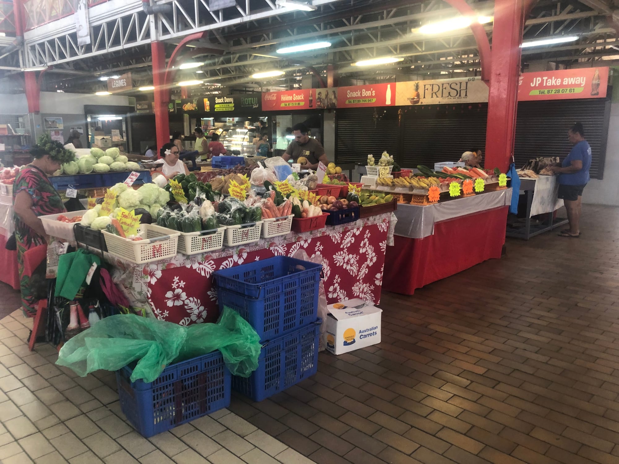 A covered market with stalls of fresh produce and goods