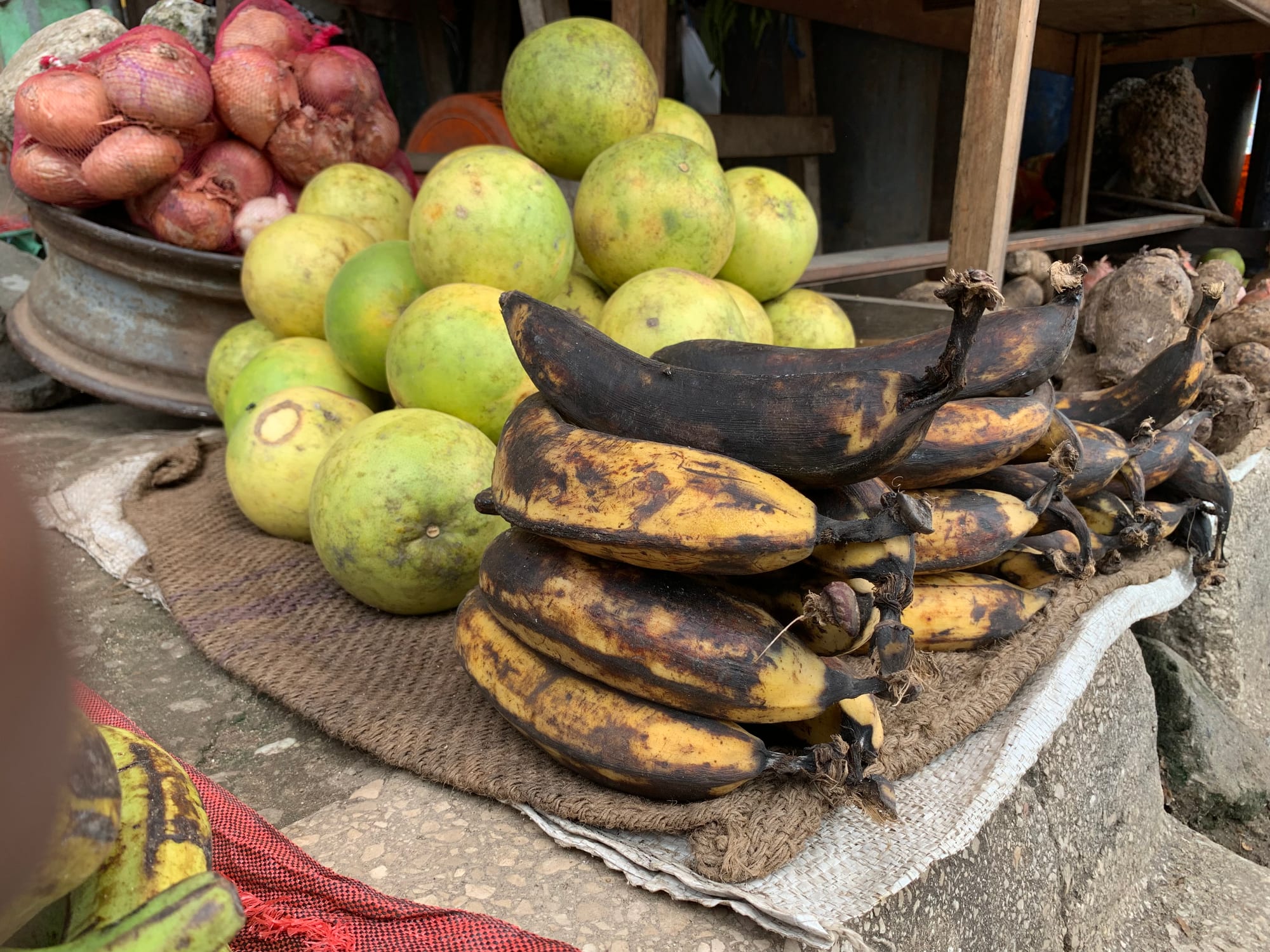 A market stall piled with fresh tropical fruit and produce