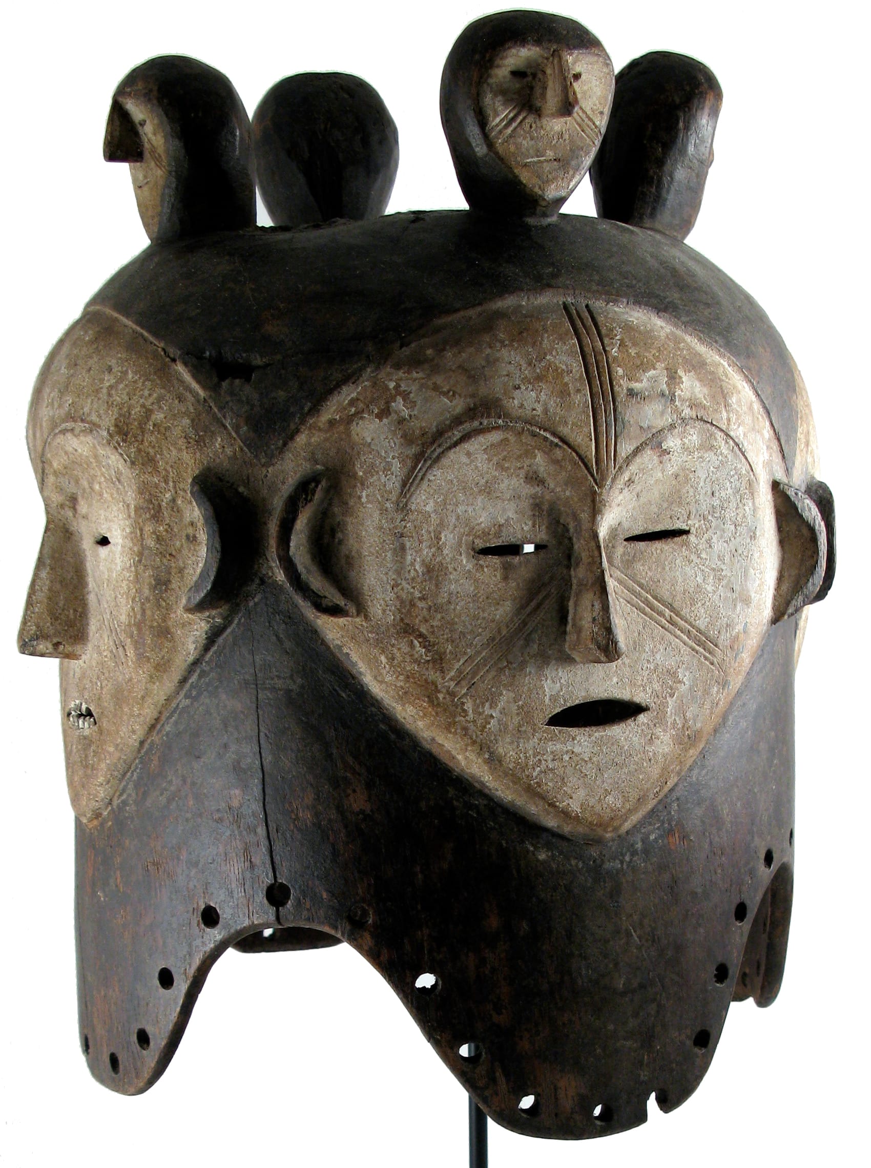 A carved wooden Fang mask with a heart-shaped face, coated white, with a narrow nose