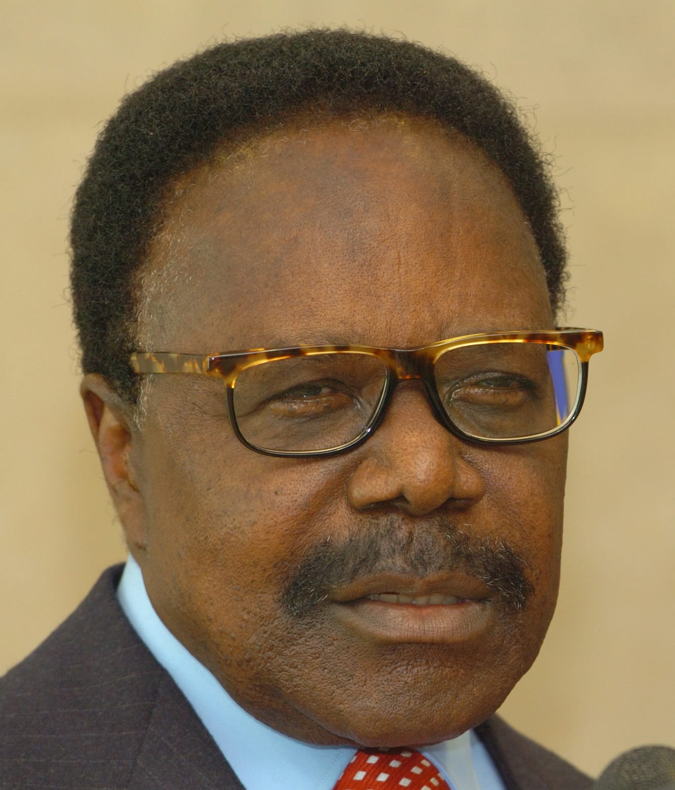 Omar Bongo in a dark suit and glasses, photographed in 2005