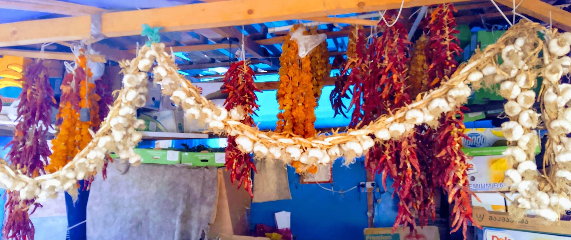 A market stall with bowls and bags of colourful spices
