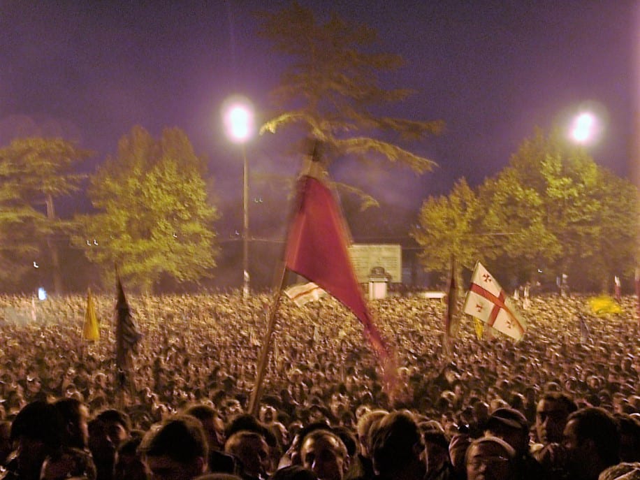 A large crowd of protesters filling a Tbilisi avenue in front of a government building in 2003