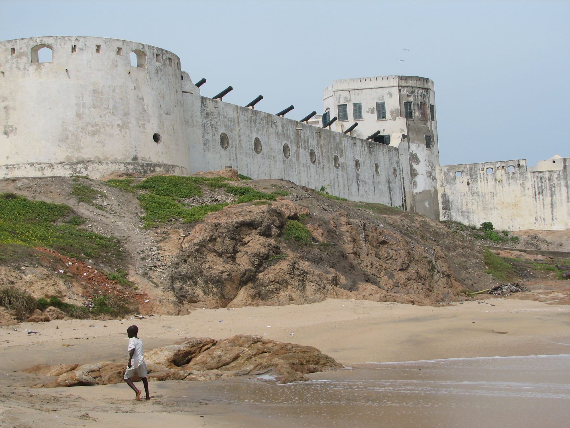 A large whitewashed colonial fort with cannon, above a rocky Atlantic shore