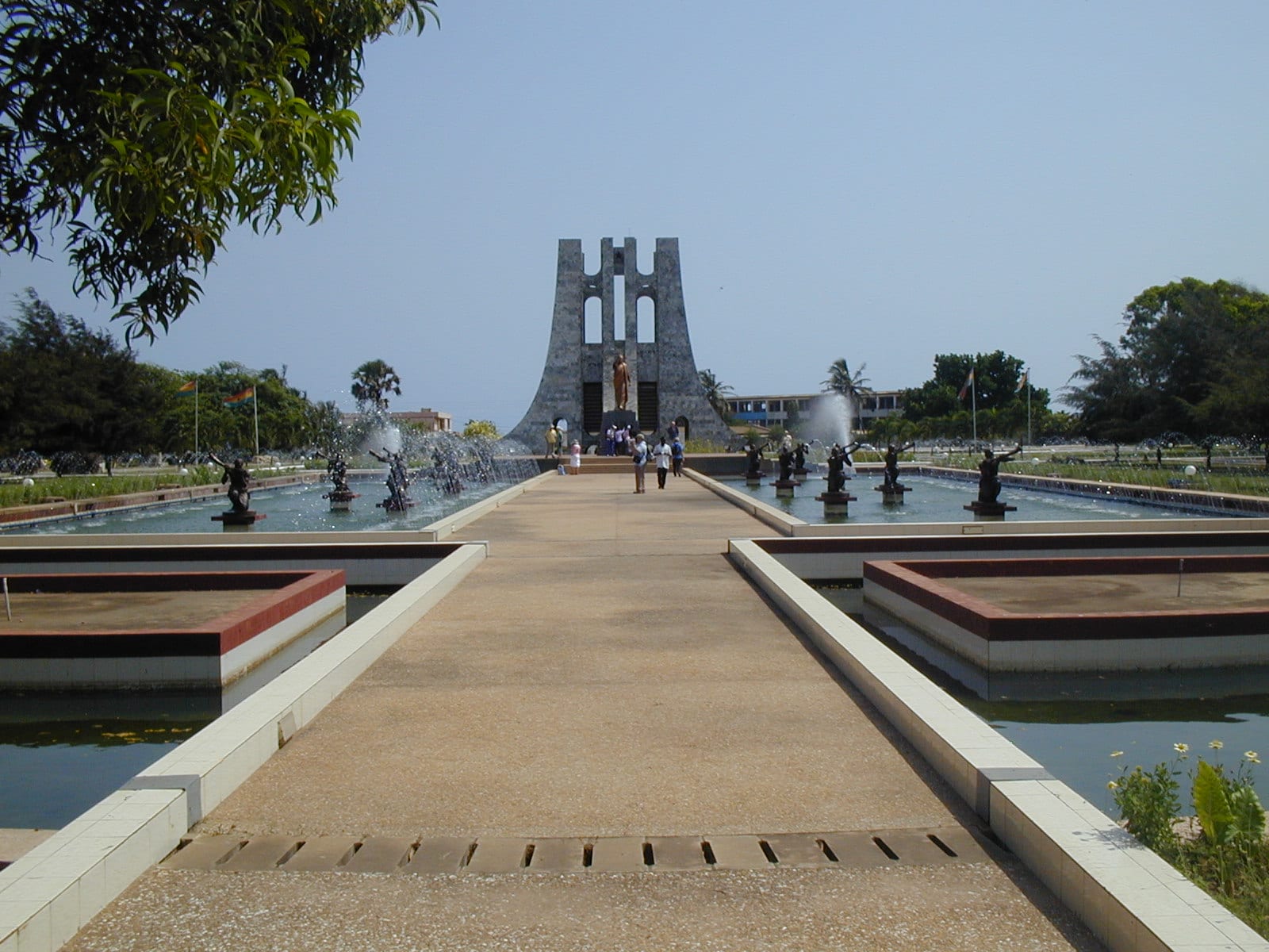 A stepped stone monument shaped like a stylised tree, with fountains in front