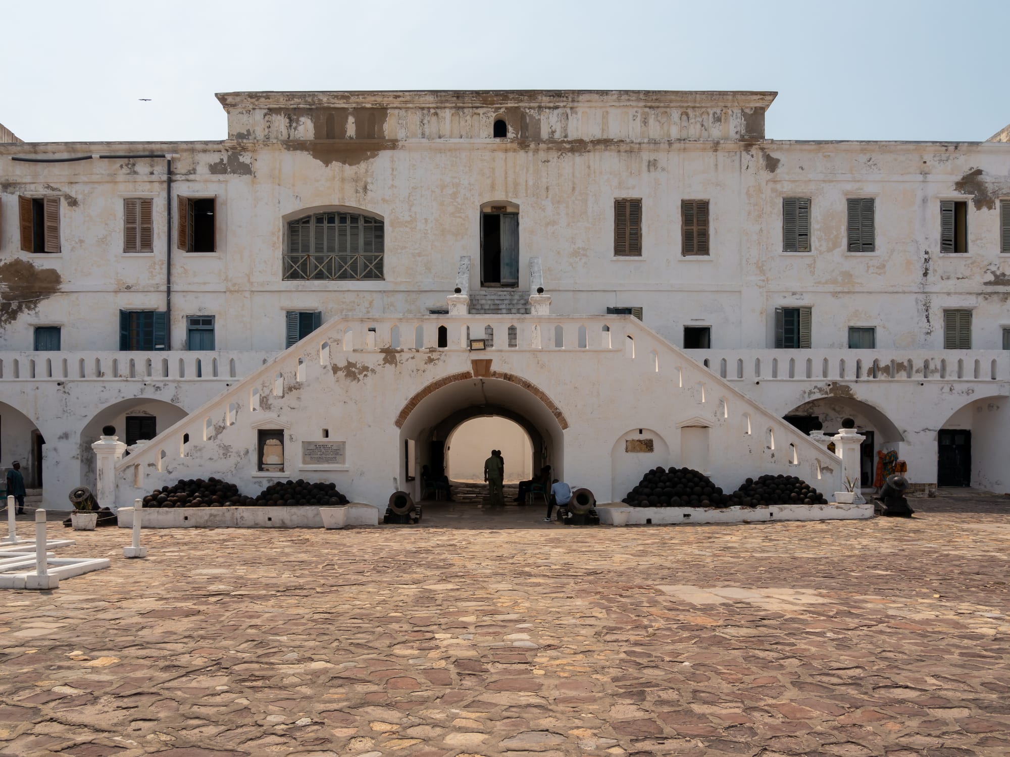 An inner courtyard of whitewashed ramparts and arched cell doorways