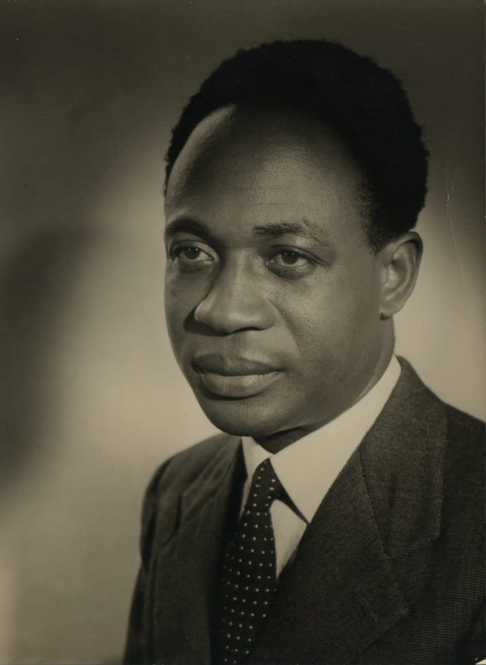 A portrait photograph of Kwame Nkrumah in a kente cloth over one shoulder