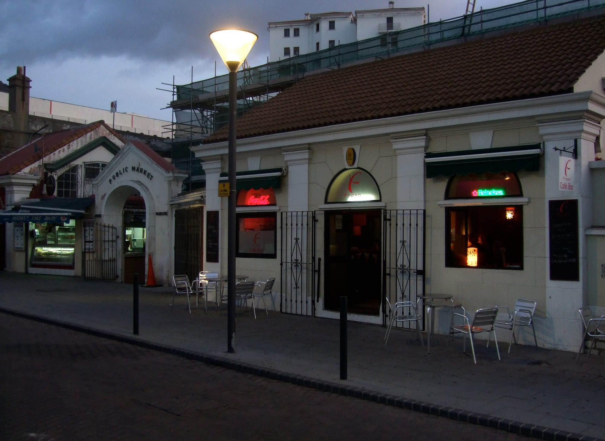 A small café bar counter inside a covered market building