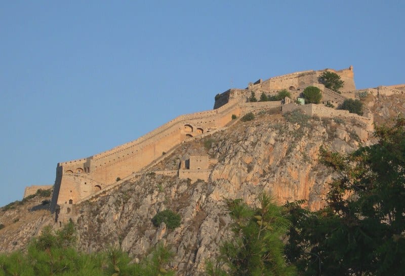 A Venetian hilltop fortress of bastions above a red-roofed seaside town