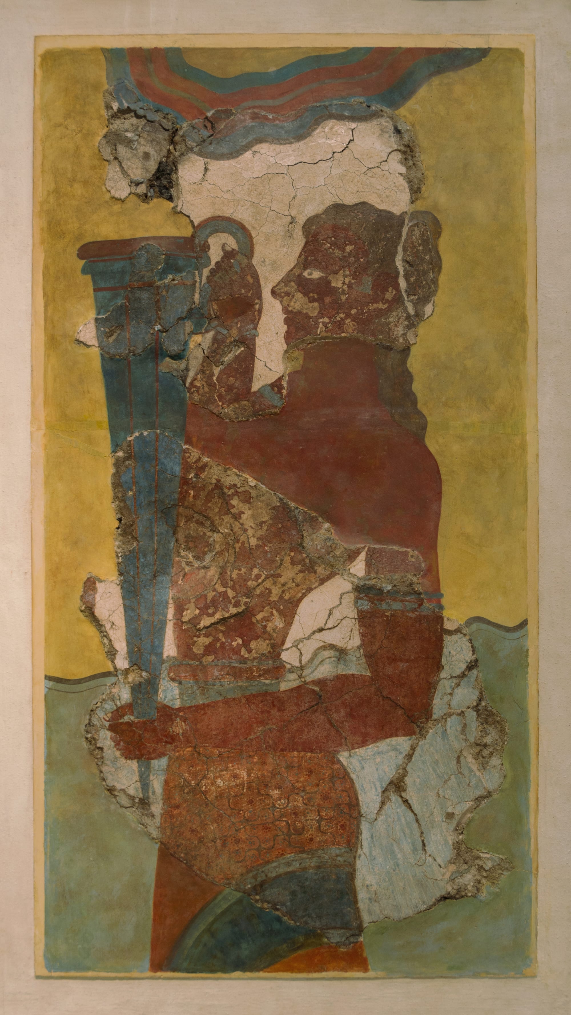 A restored Minoan fresco of a young man in a kilt carrying a tall conical vessel