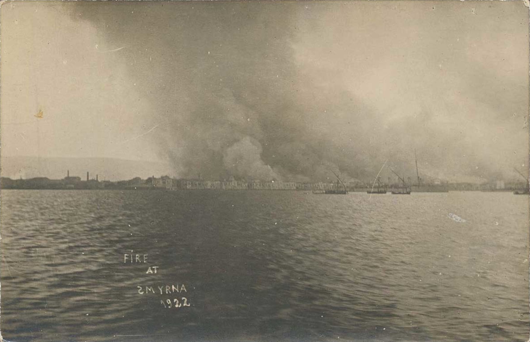 A waterfront city engulfed in smoke and flames, photographed from a warship in 1922