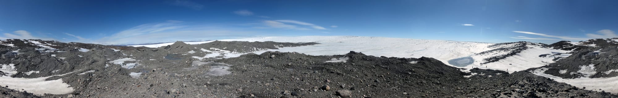 A grey-white expanse of glacier ice stretching flat to the horizon