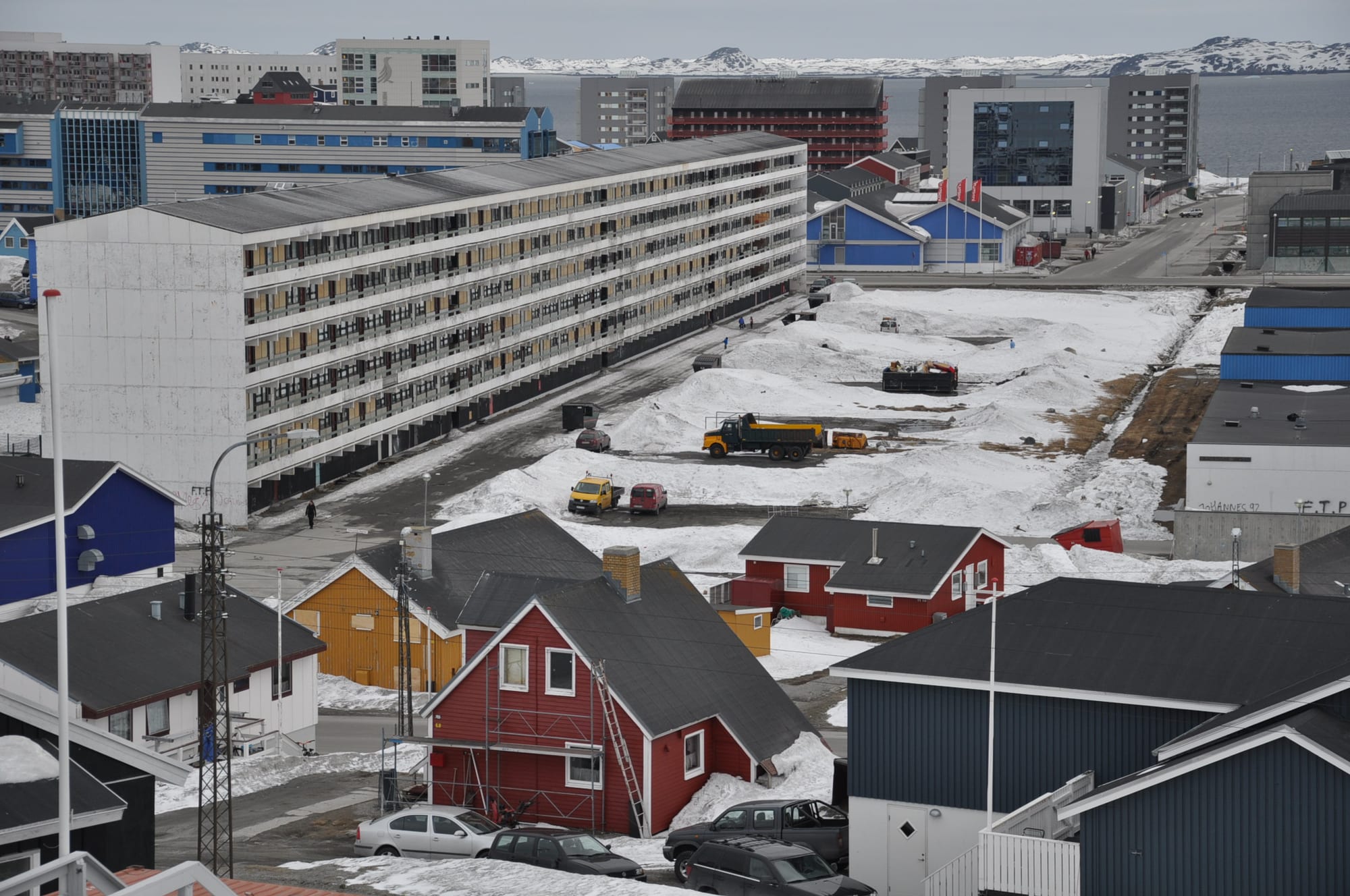 A large plain white apartment block dominating the low-rise centre of Nuuk