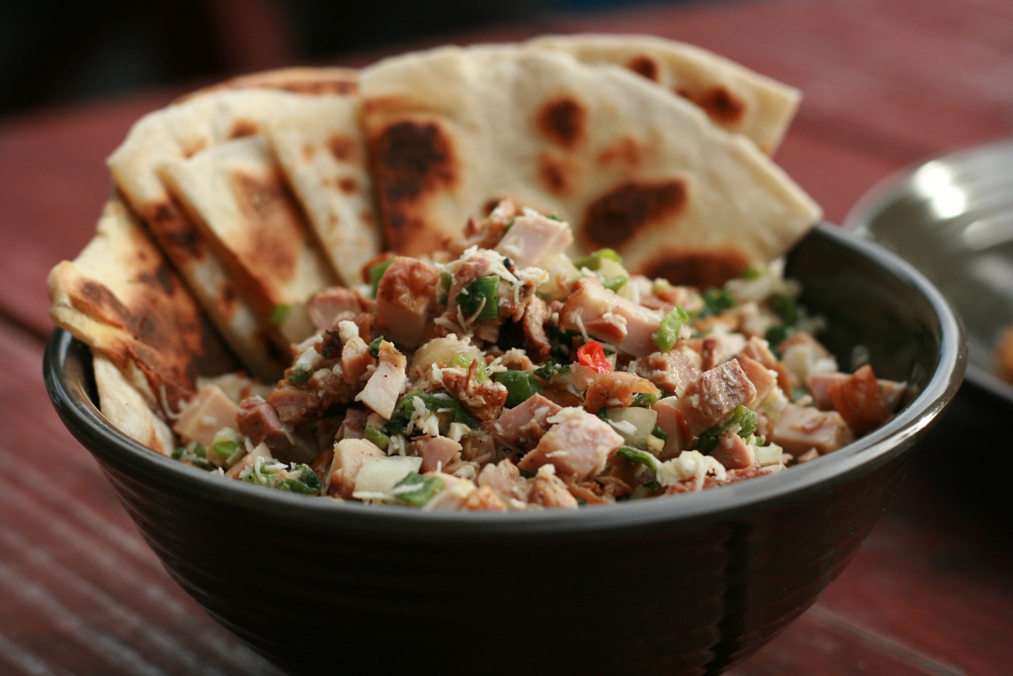 Finely chopped seasoned chicken served with flatbread
