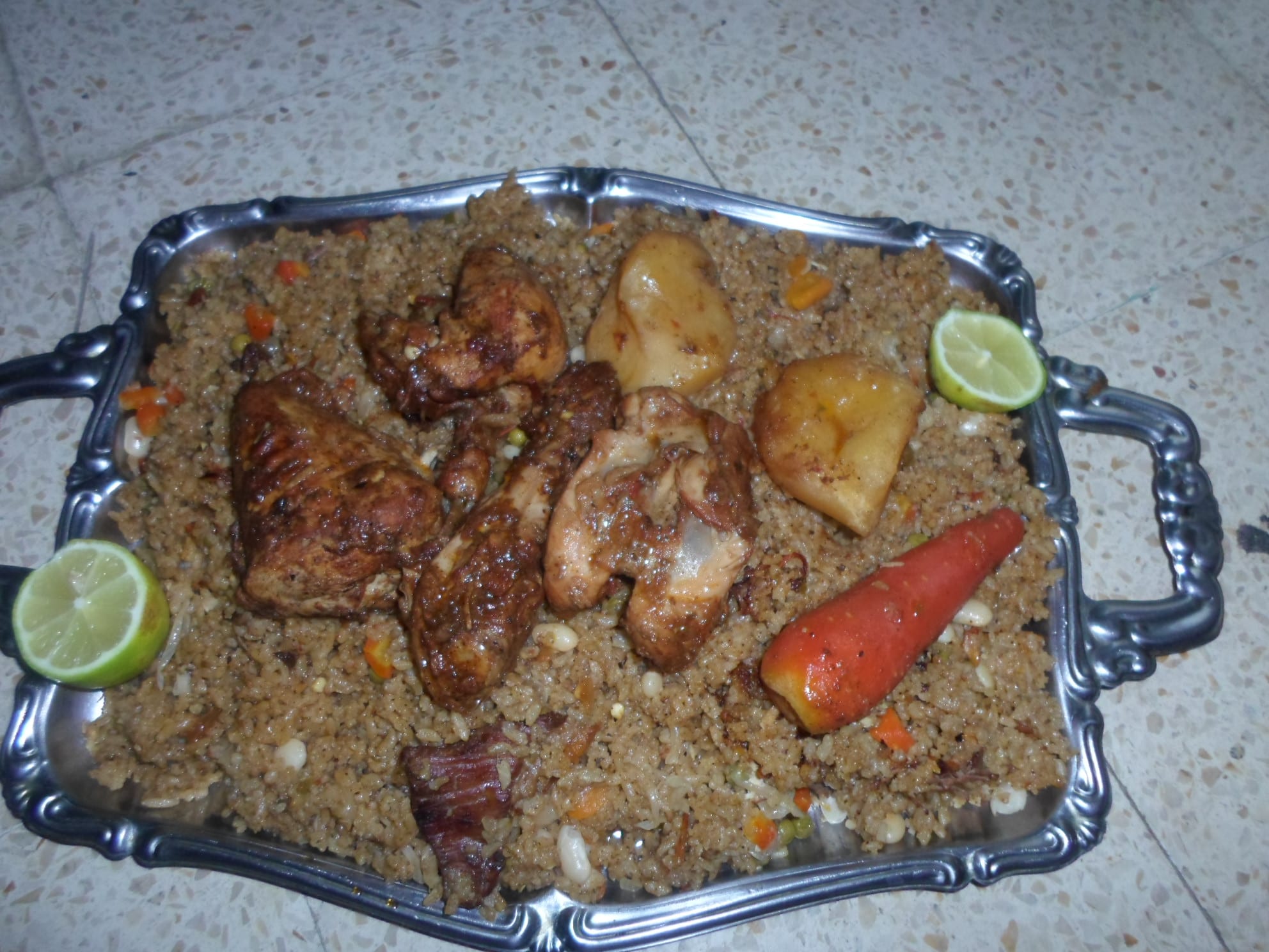 A plate of reddish, oil-glossed rice with pieces of meat