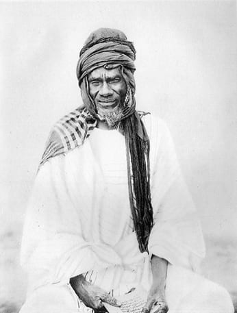 A 19th-century photograph of Samori Touré in white robes and turban