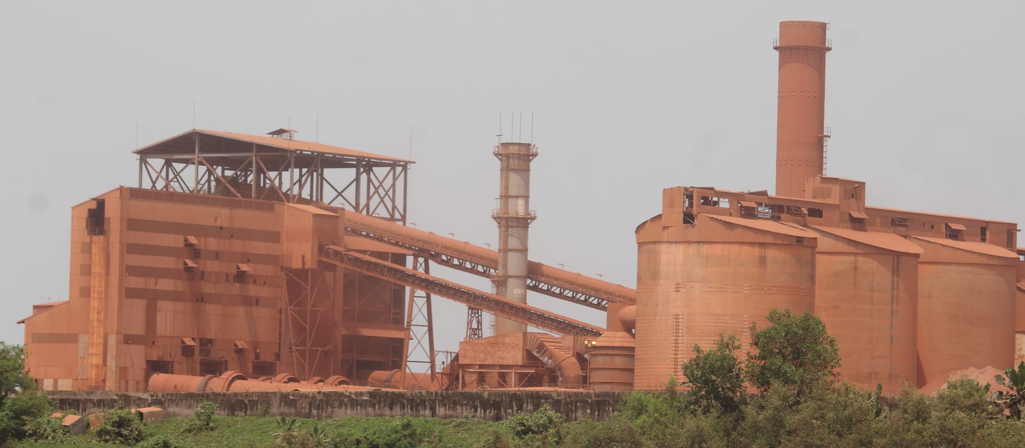 An industrial bulk carrier loading at a bauxite export terminal on the Guinean coast