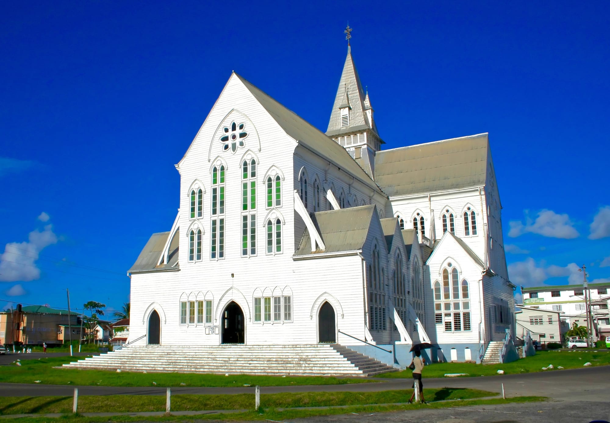 A tall white-painted wooden Gothic cathedral with a pointed spire