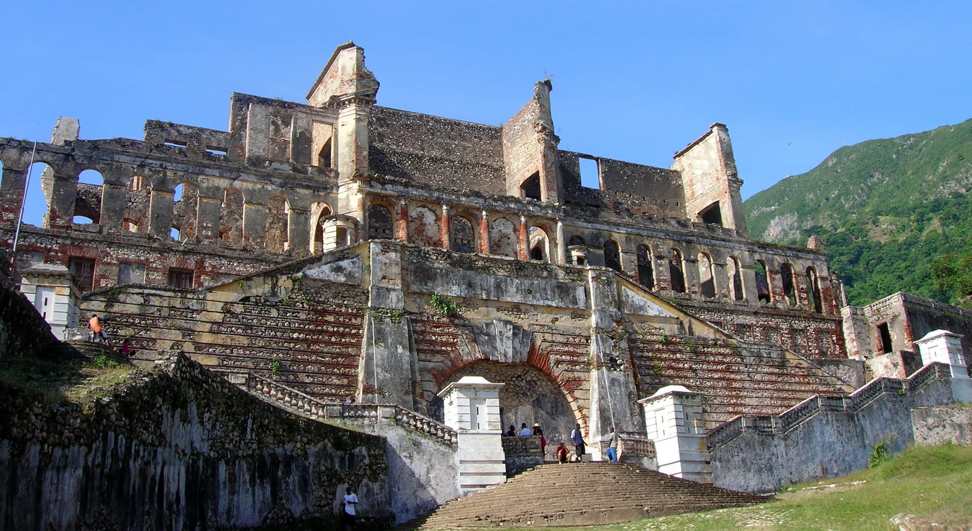 The grand ruined stone facade and staircase of an early-19th-century palace