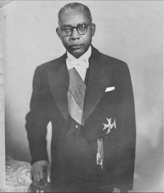 A 1957 presidential portrait of François Duvalier in glasses and a dark suit