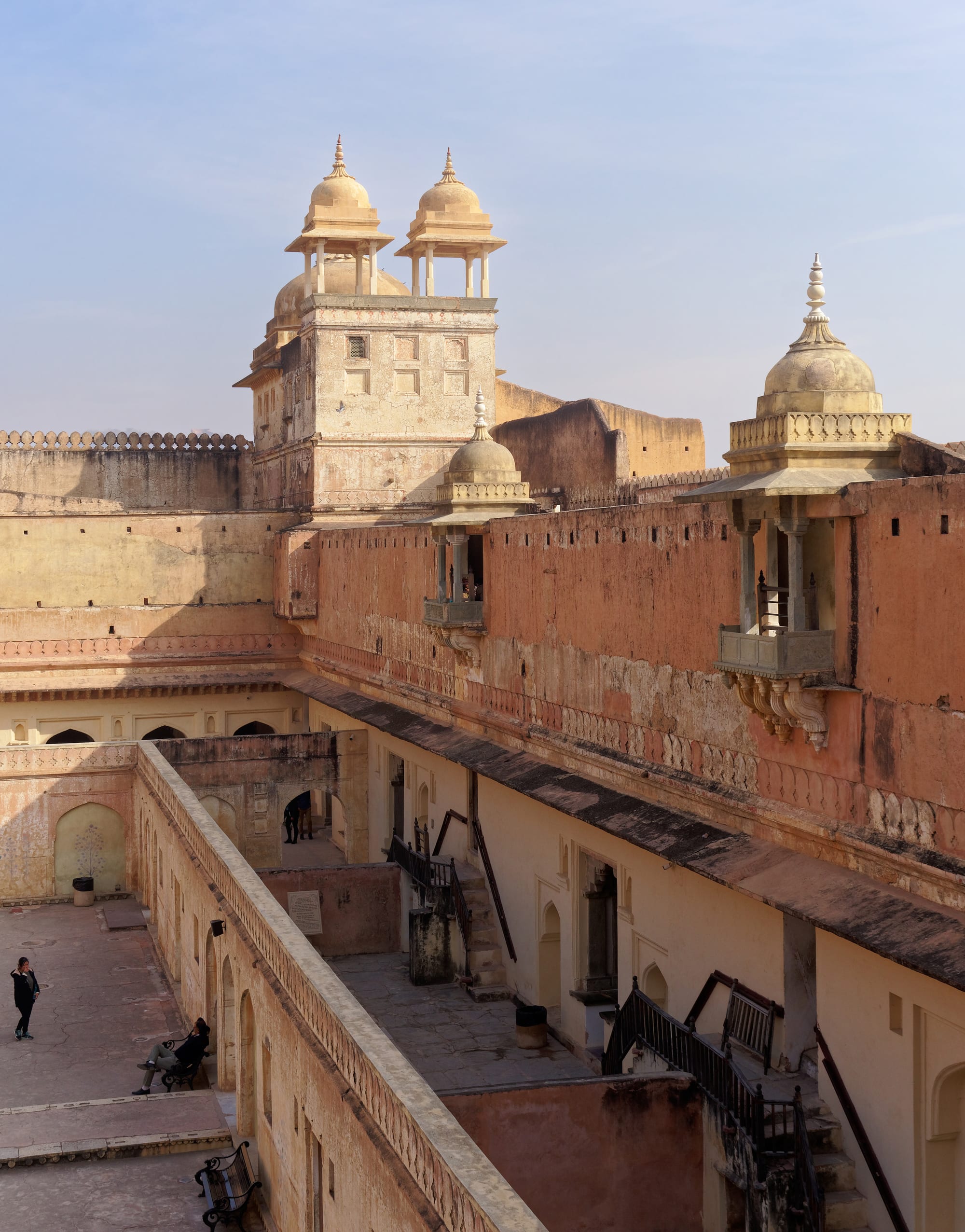 A sprawling honey-coloured fort-palace on a ridge above a lake, ringed by walls