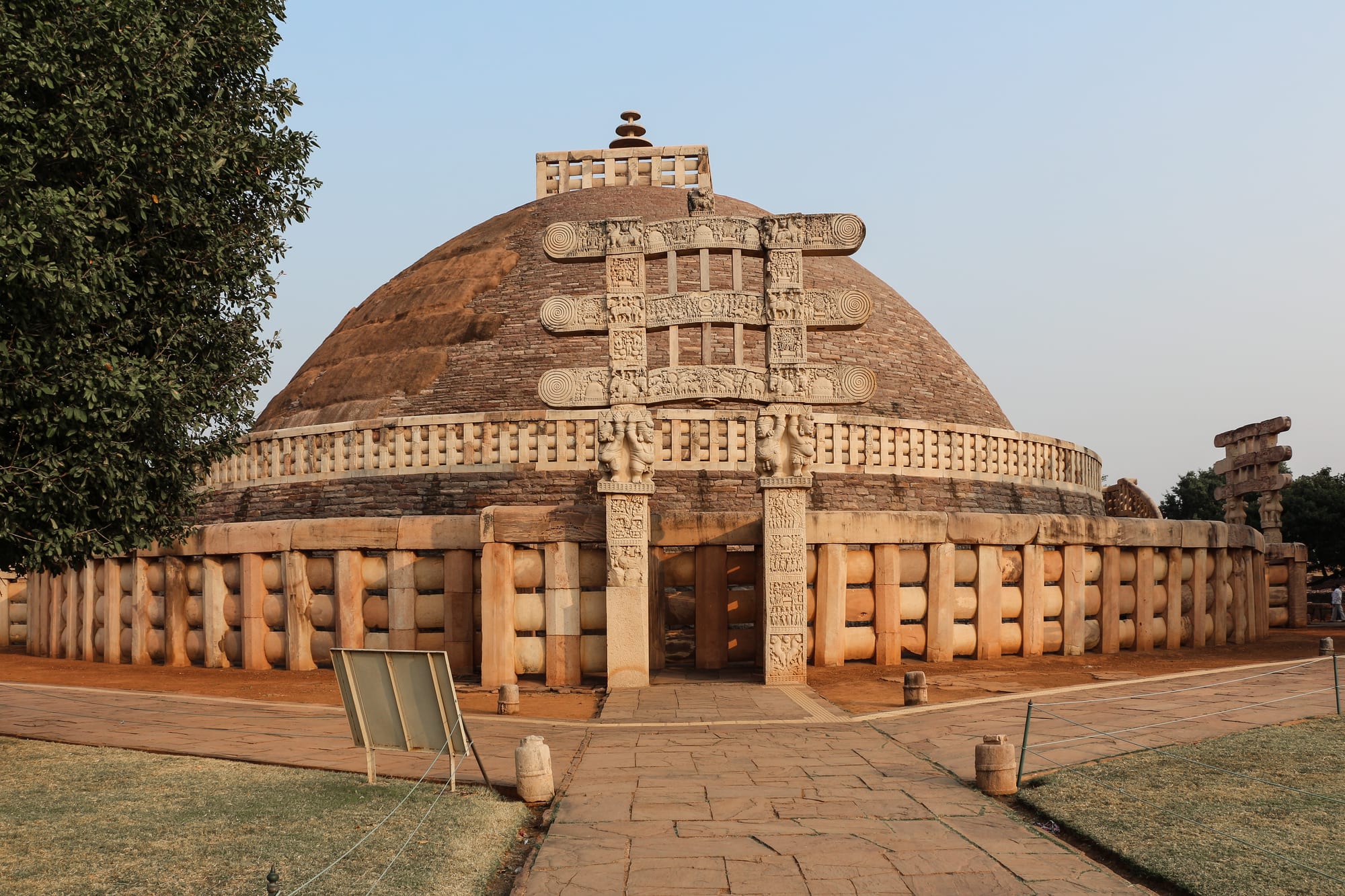 A large hemispherical Buddhist stupa with carved stone gateways at Sanchi