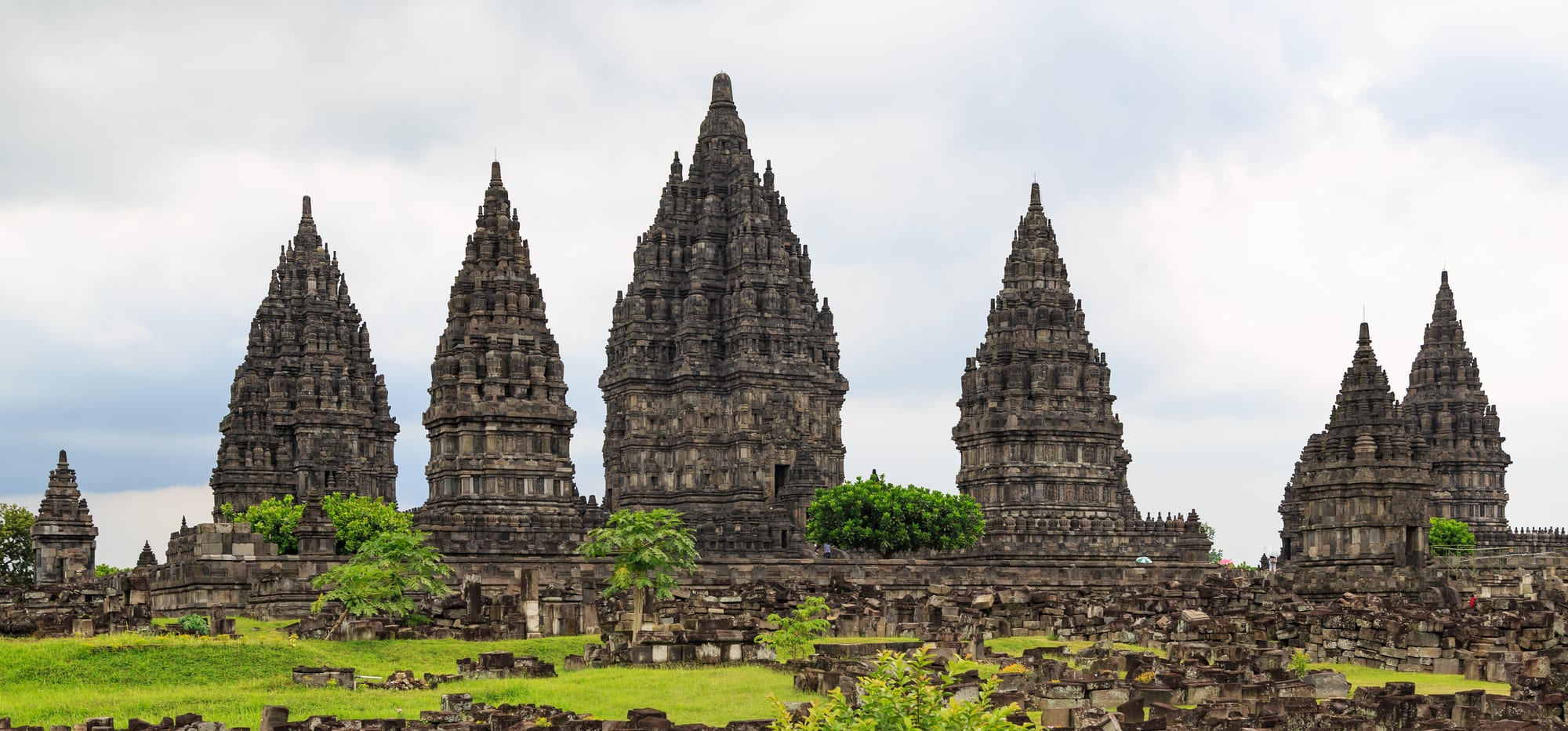 A cluster of tall, sharply pointed stone Hindu temple towers