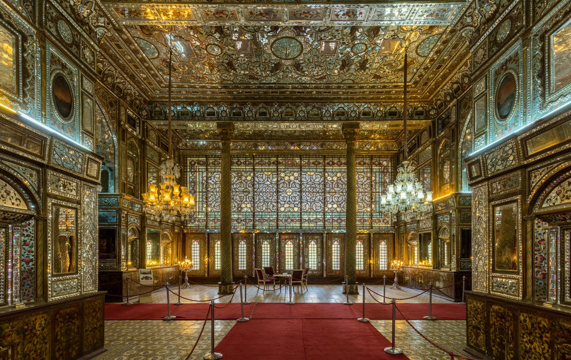 An ornate palace facade covered in intricate tilework and mirrored arches
