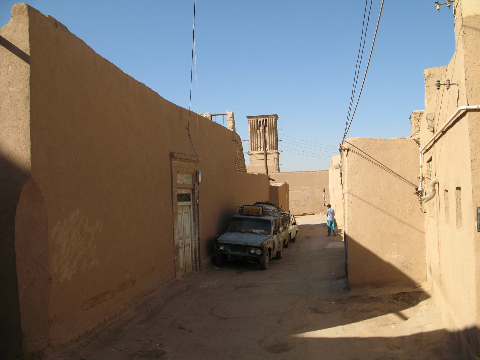 A rooftop maze of mud-brick domes and tall chimney-like towers under a hazy sky