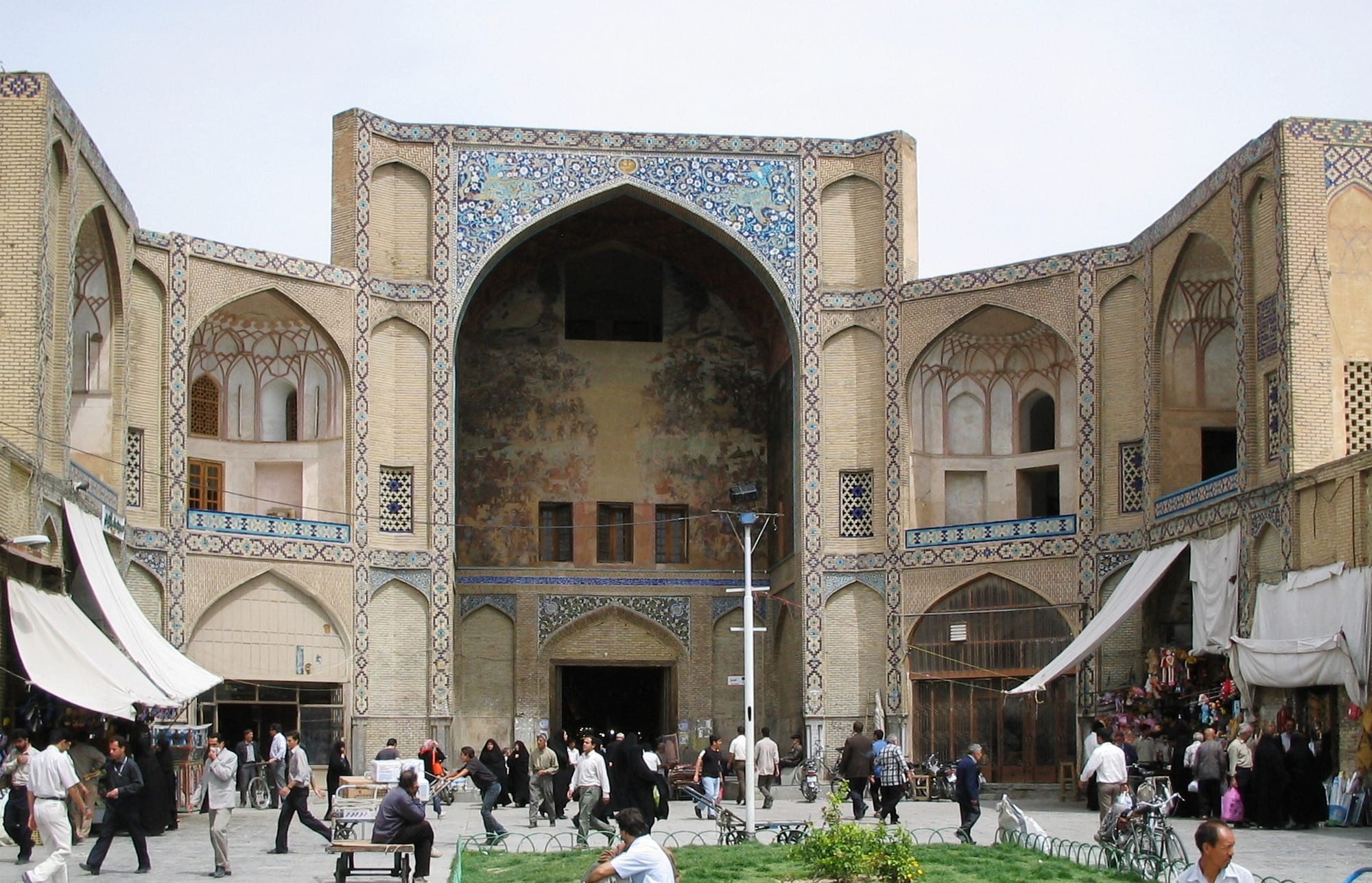 An ornate tiled bazaar entrance on a large public square