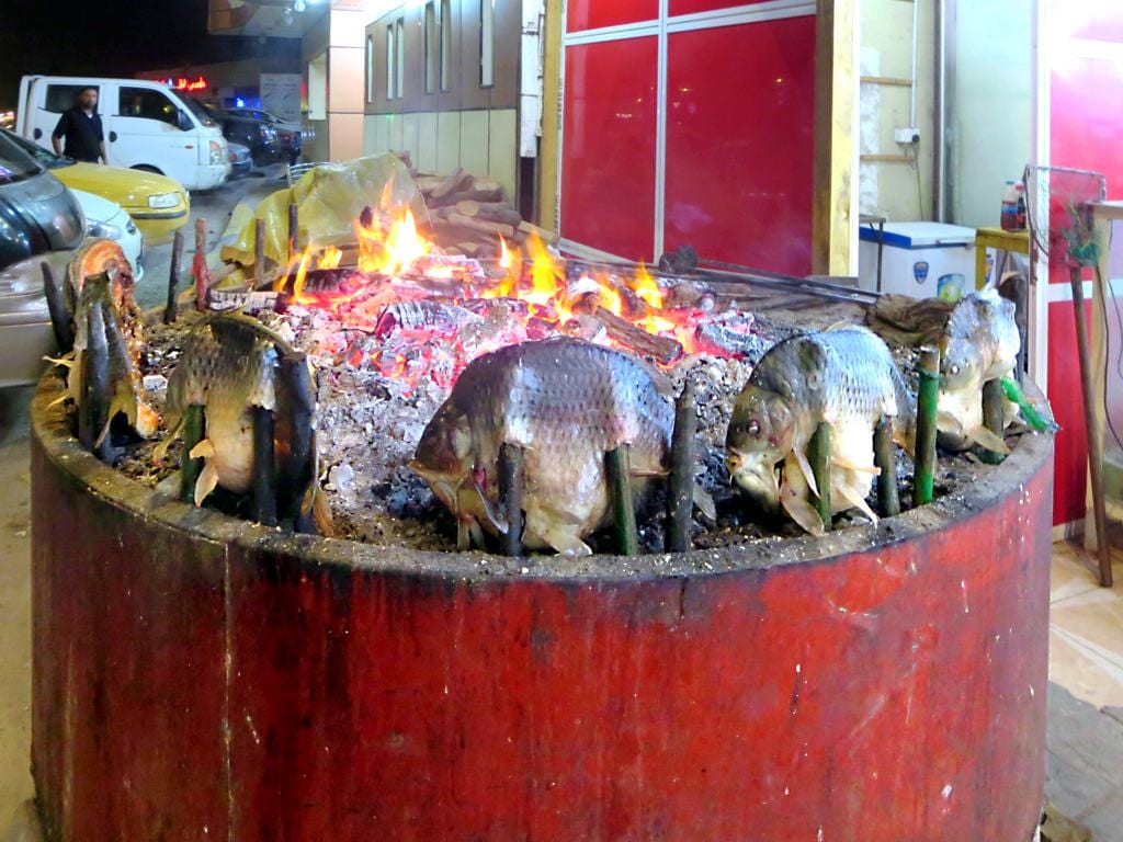 A whole grilled fish served on a plate