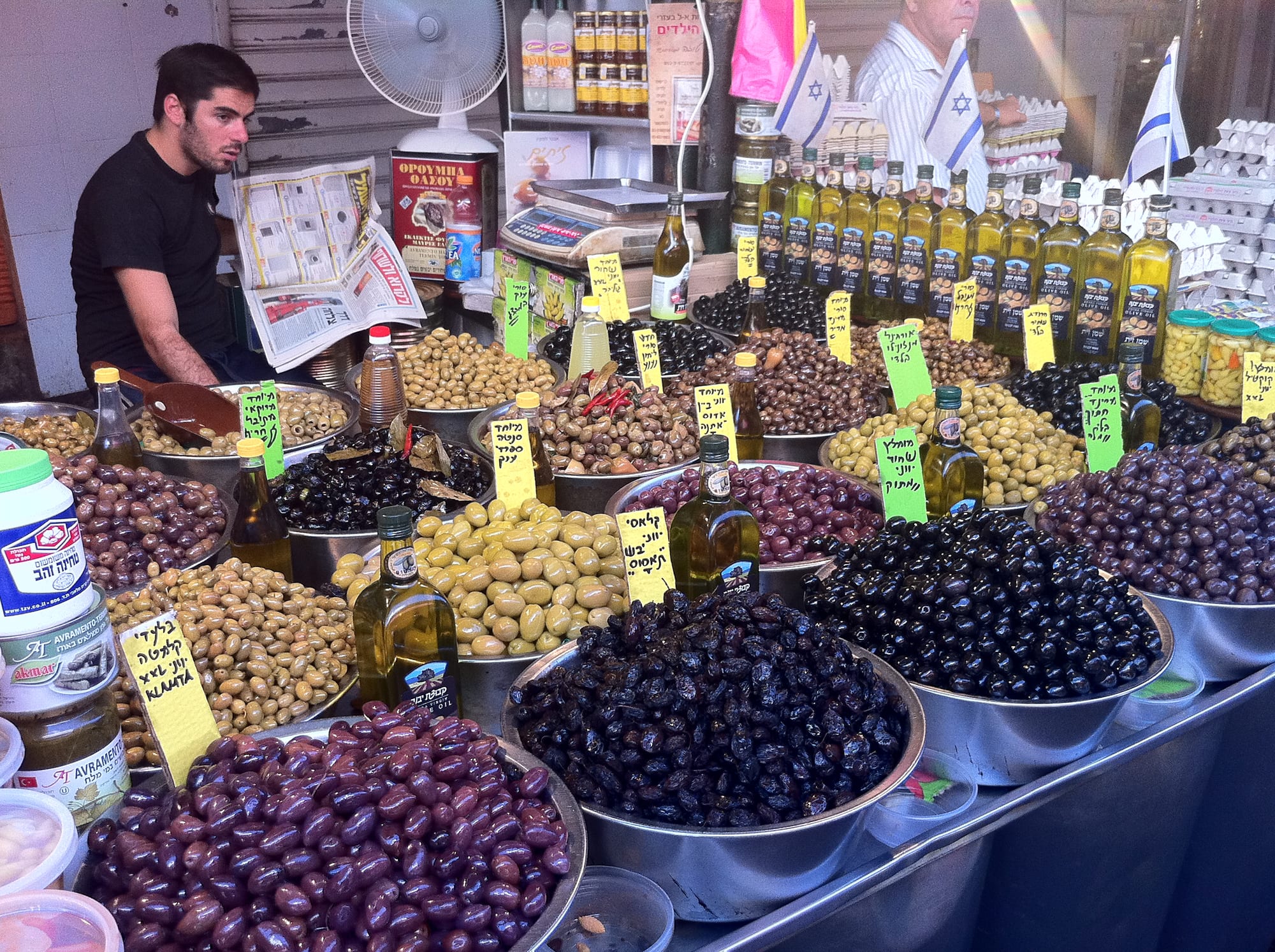 A market stall with bowls of different types of olives