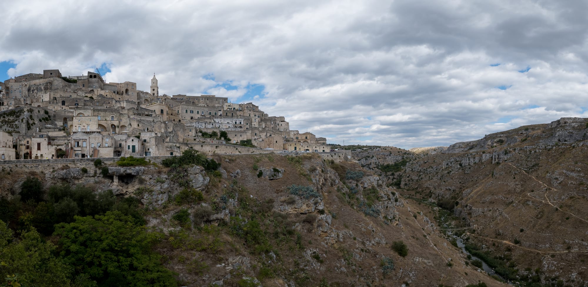 A dense honeycomb of pale stone houses and cave dwellings piled up a ravine