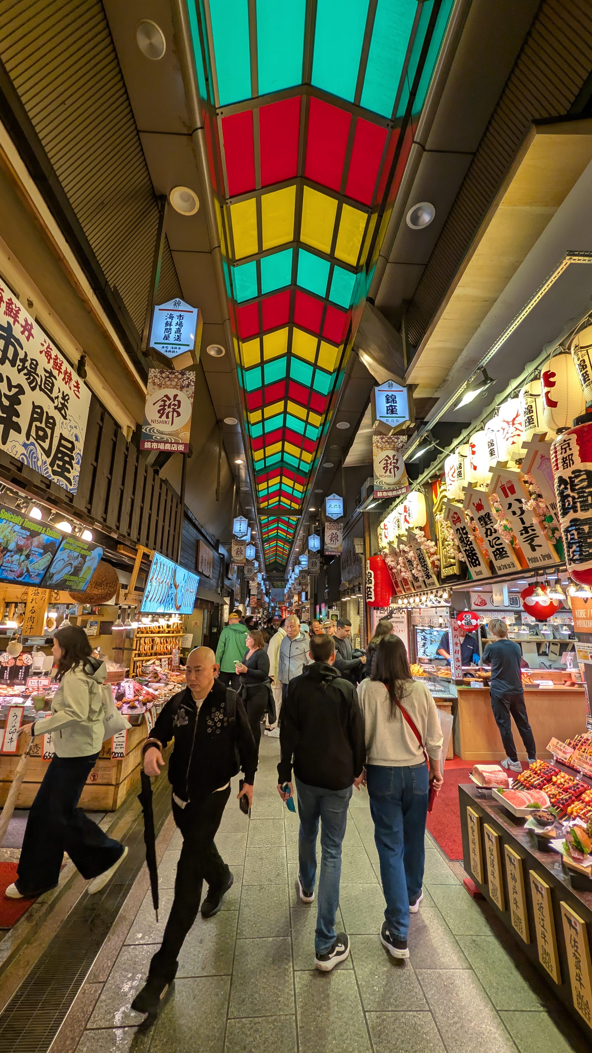 A narrow covered market street lined with food stalls