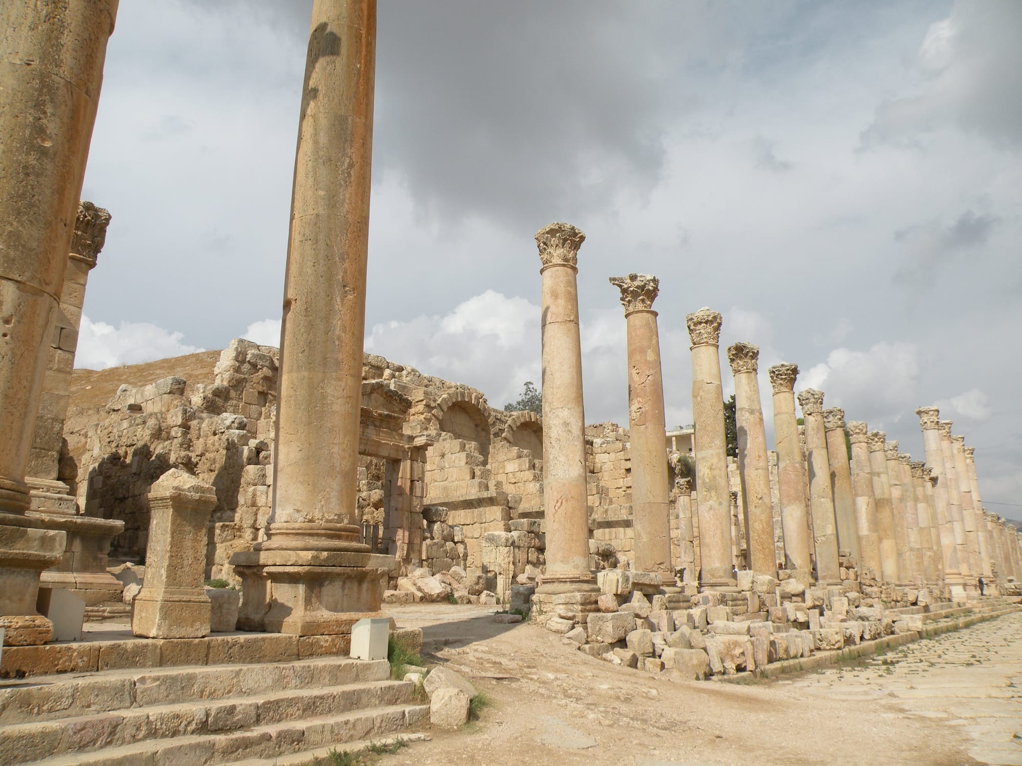 A long colonnaded Roman street leading to an oval plaza ringed by columns