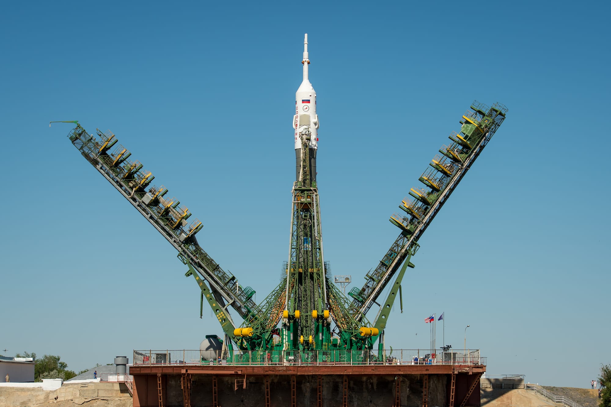 A Soyuz rocket on its launch pad at Baikonur with the gantry towers around it